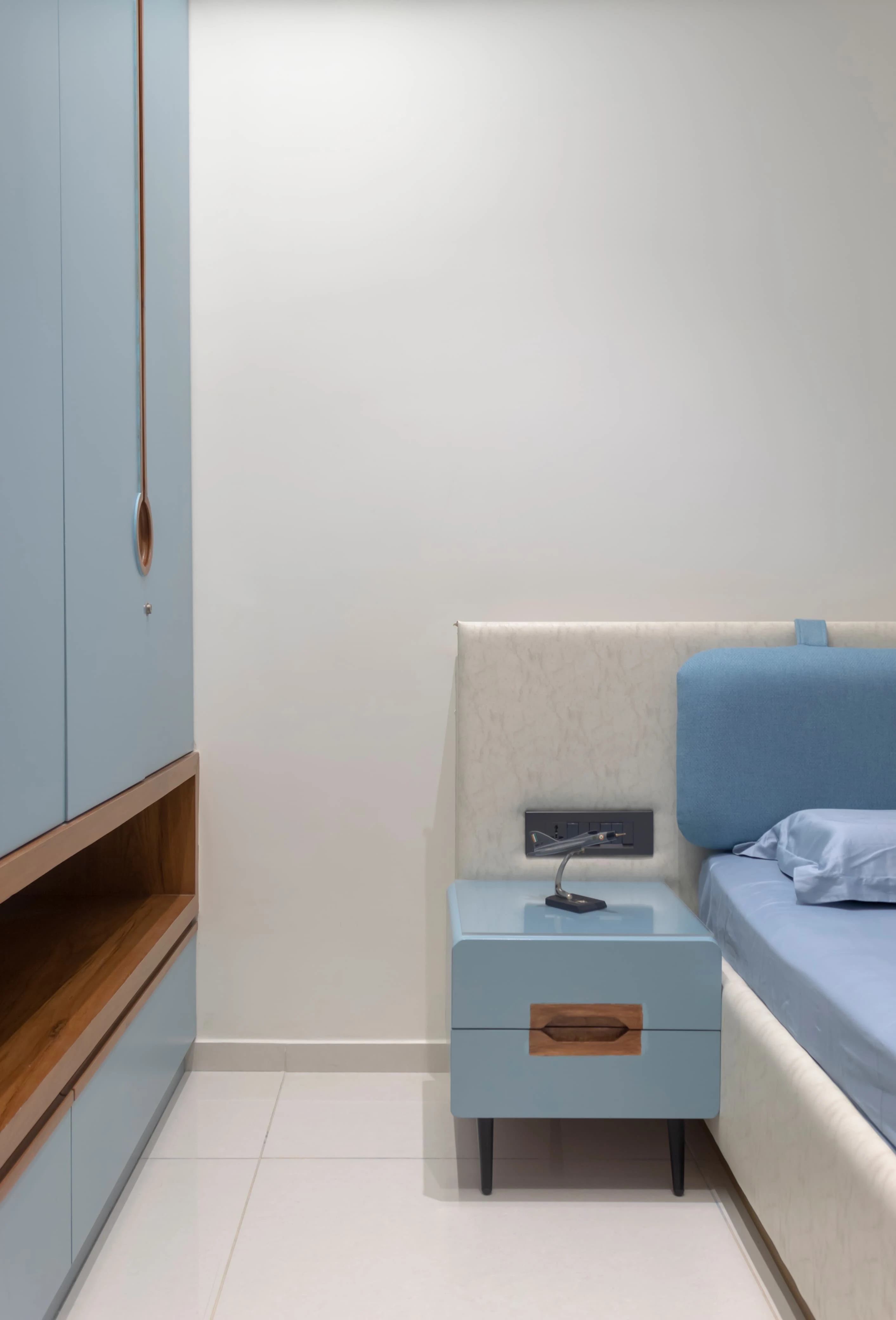 Bedroom with blue wardrobe and matching side table